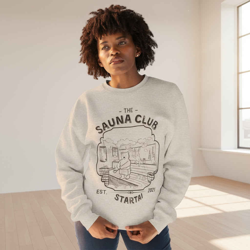 Person wearing a gray sweatshirt with 'The Sauna Club' hand drawn design