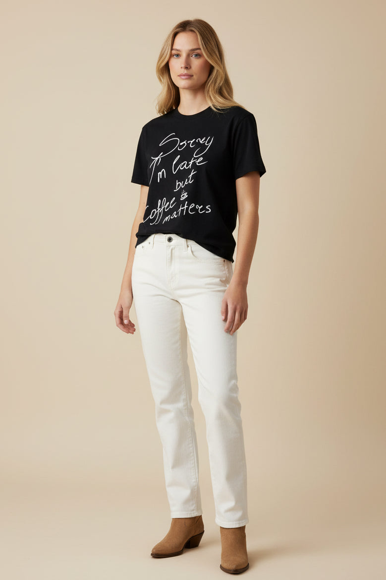 Black t-shirt with white text 'Sorry I'm late but coffee matters' on a white background