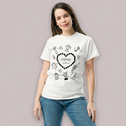 Woman wearing a white t-shirt with coffee-themed graphics on a plain background